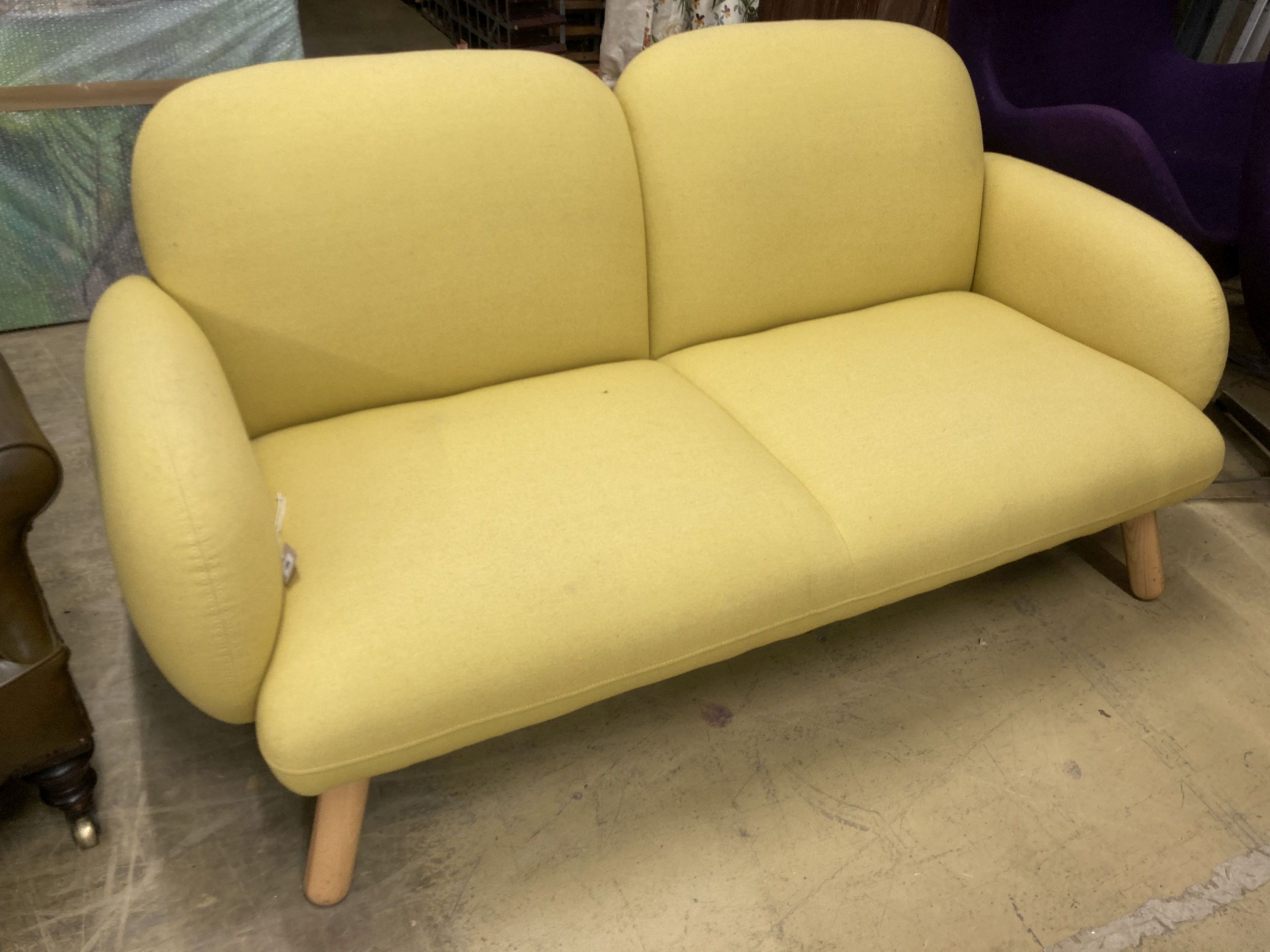 A contemporary pale yellow fabric two seater settee, length 160cm, depth 80cm, height 76cm